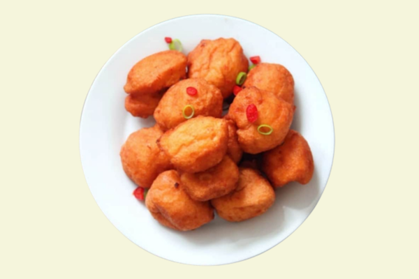 A plate of golden, crispy akara, a traditional dish of fried bean cakes, showcasing its crunchy texture and delicious golden-brown color.