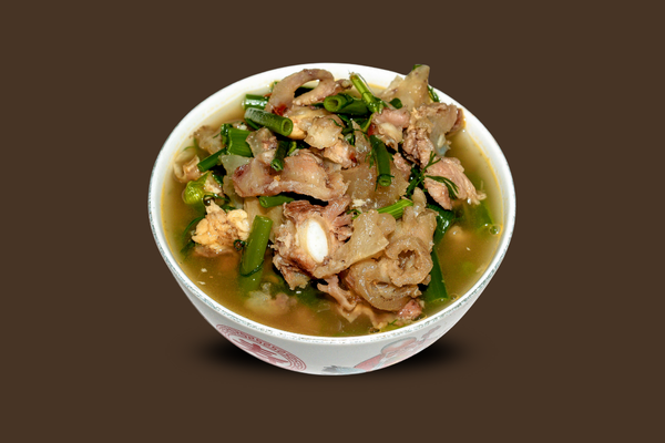 A steaming bowl of pepper soup, filled with vibrant ingredients, highlighting the rich flavors and warmth of this comforting dish.